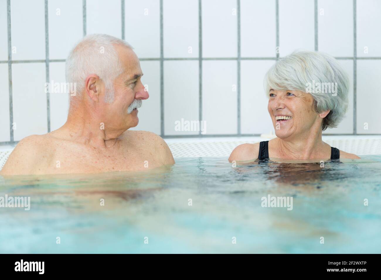 senior couple relaxing at a swimming pool Stock Photo - Alamy