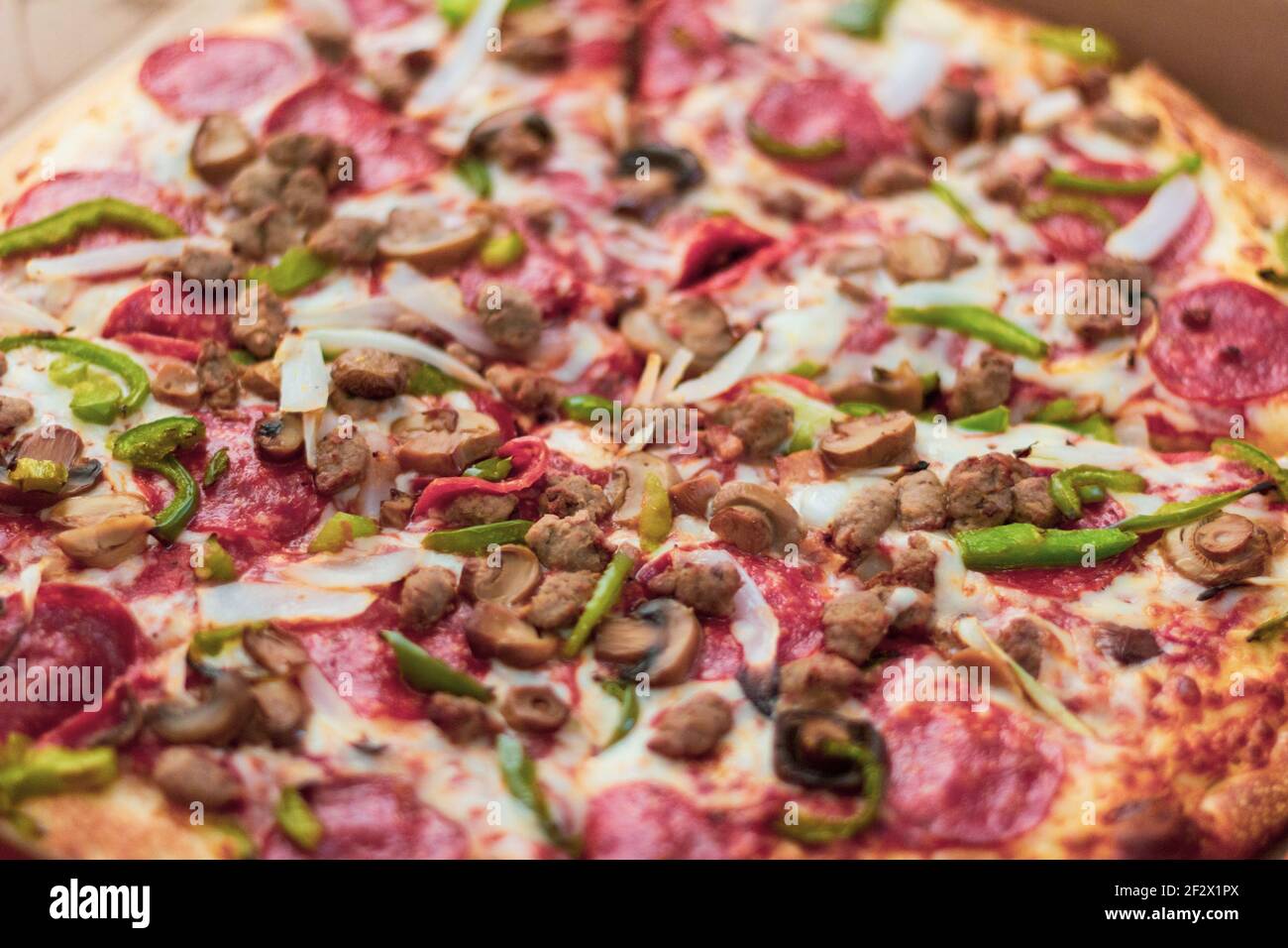 Photograph of a pepperoni, mushroom, pepper and onion pizza Stock Photo Alamy