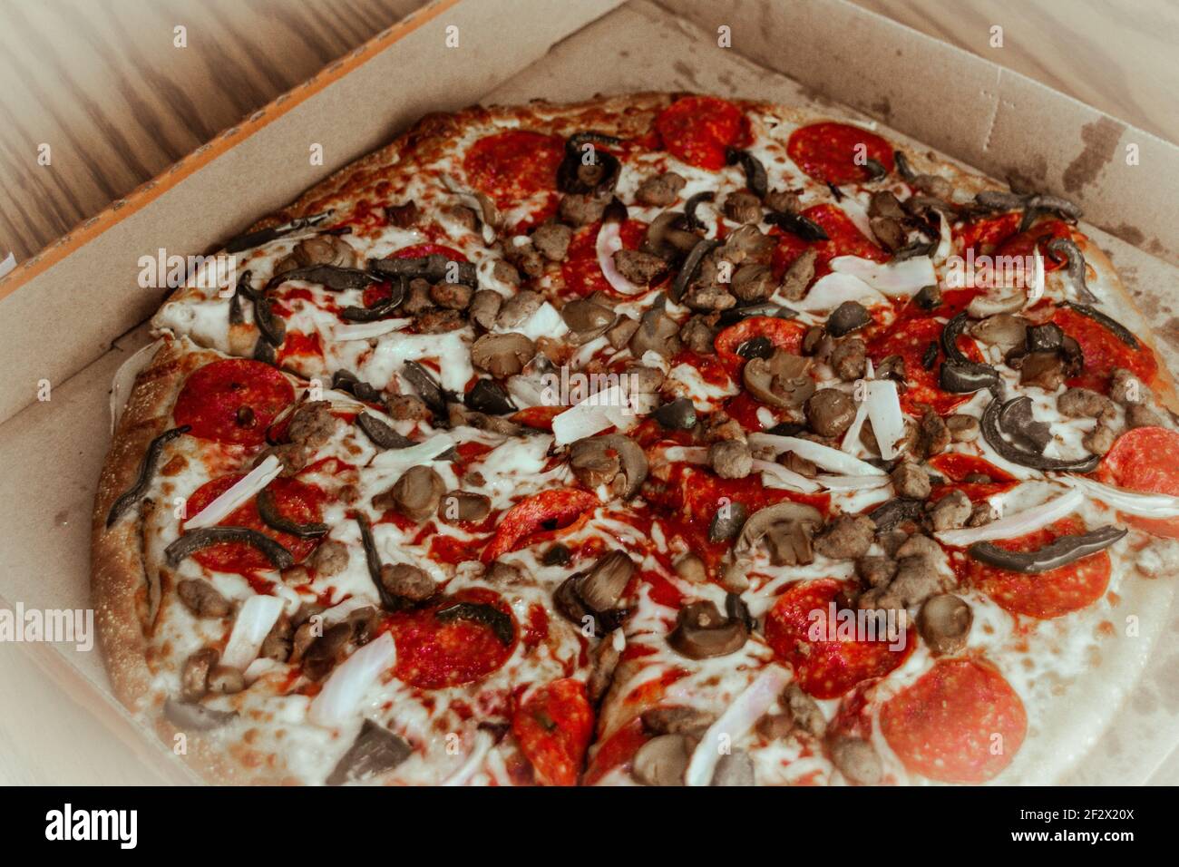 Photograph of a pepperoni, mushroom, pepper and onion pizza Stock Photo Alamy