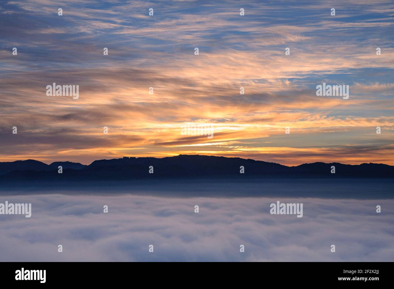 Sunrise with a sea of clouds over the Sau Reservoir seen from Roca del Migdia summit (Collsacabra, Catalonia, Spain) Stock Photo