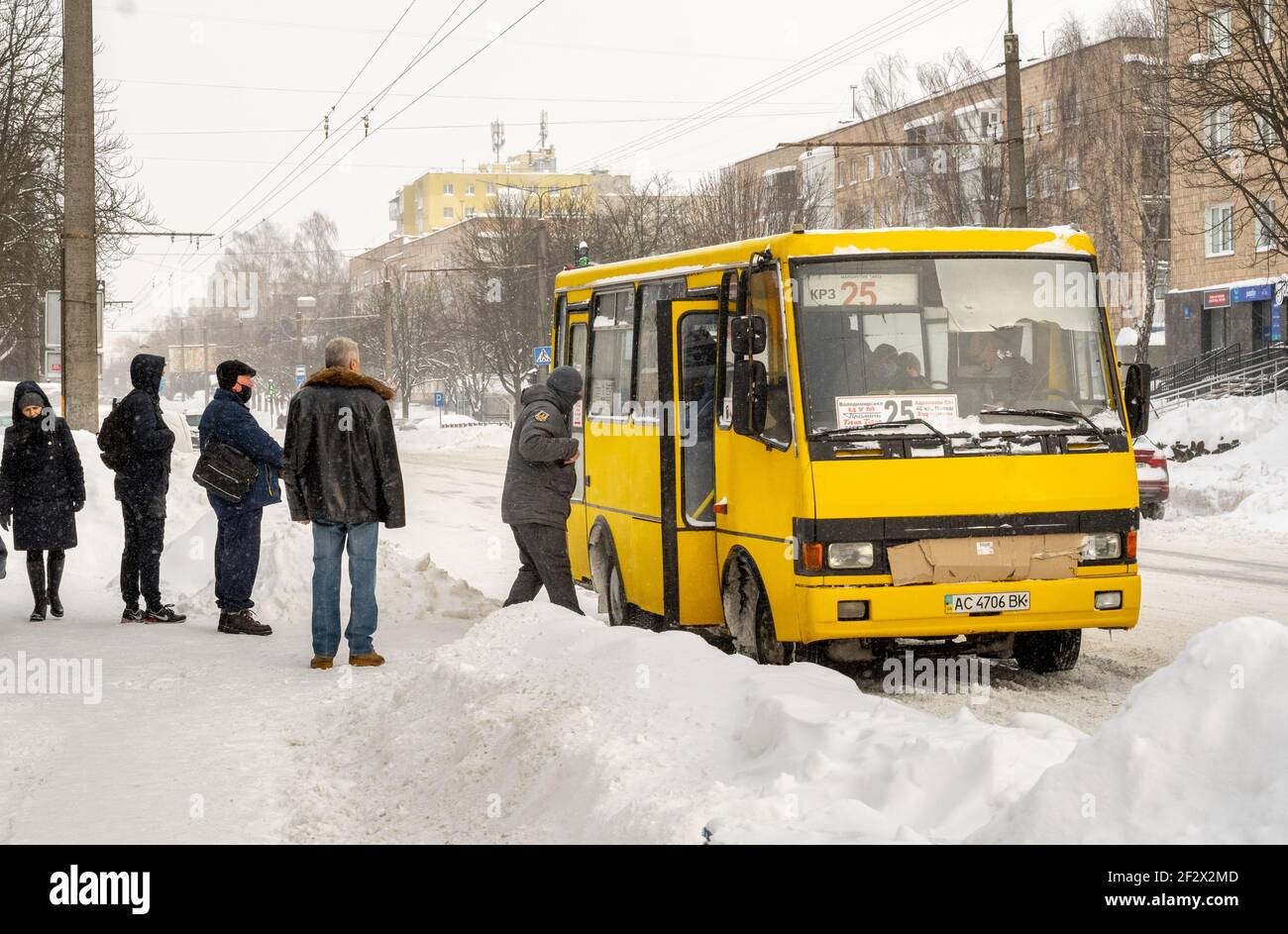 Lutsk, Ukraine - February 12,2020: City street after blizzard. Record-breaking amounts of snow. People on street after snow storm. Uncleaned slippery Stock Photo