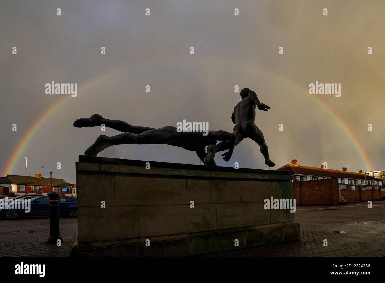 Northampton, UK. 13th Mar, 2021. Rainbow over the Bronze statue at the