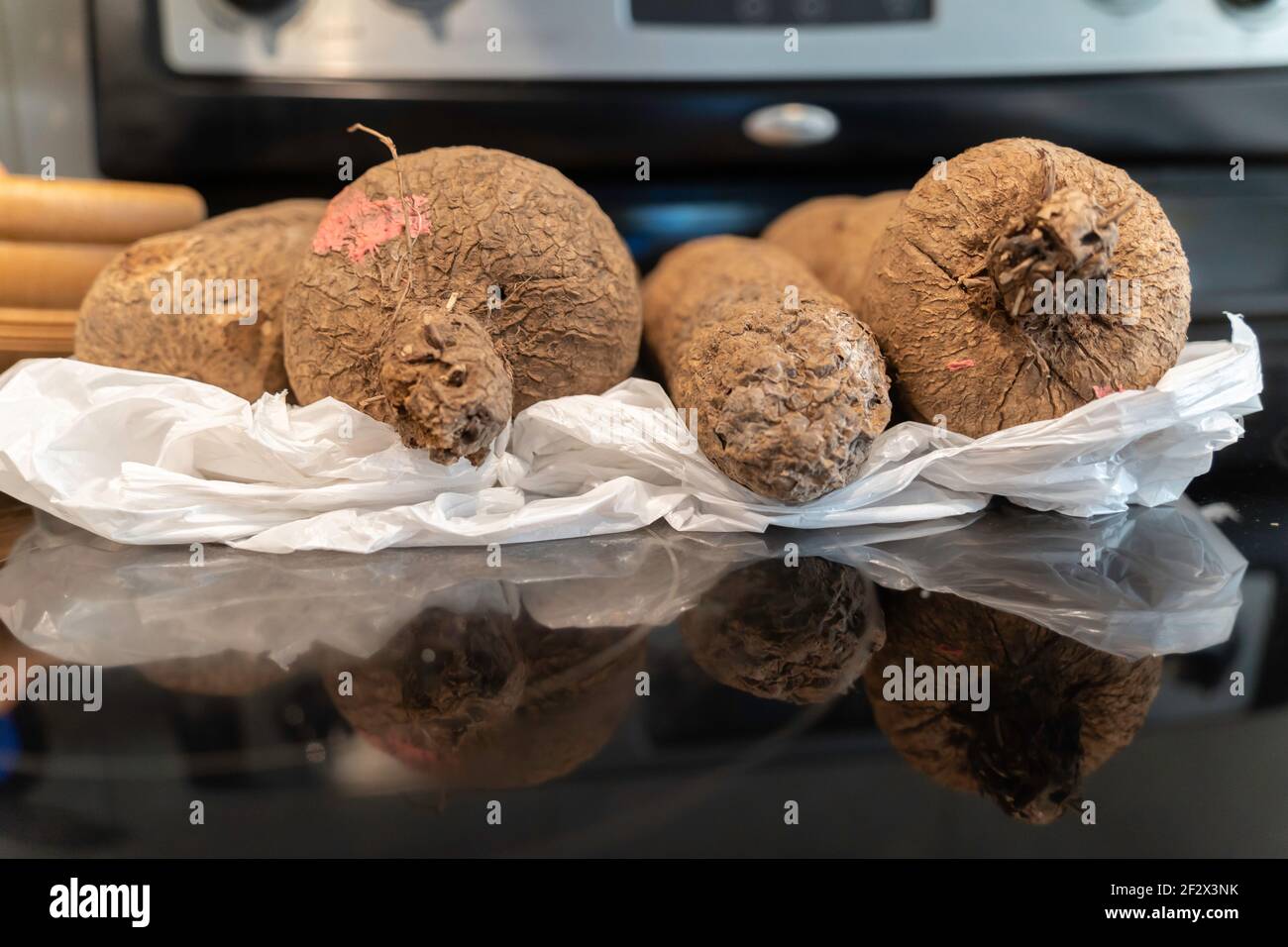 Pile of Nigerian African Yam tubers in a kitchen Stock Photo