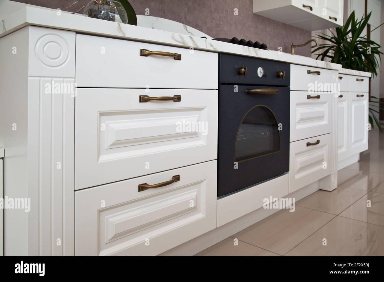 Interior of luxurious modern kitchen equipment, white cabinets Stock Photo