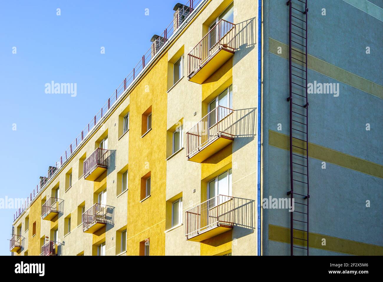 thermally insulated and visually restored apartment house facade on a background of blue sky