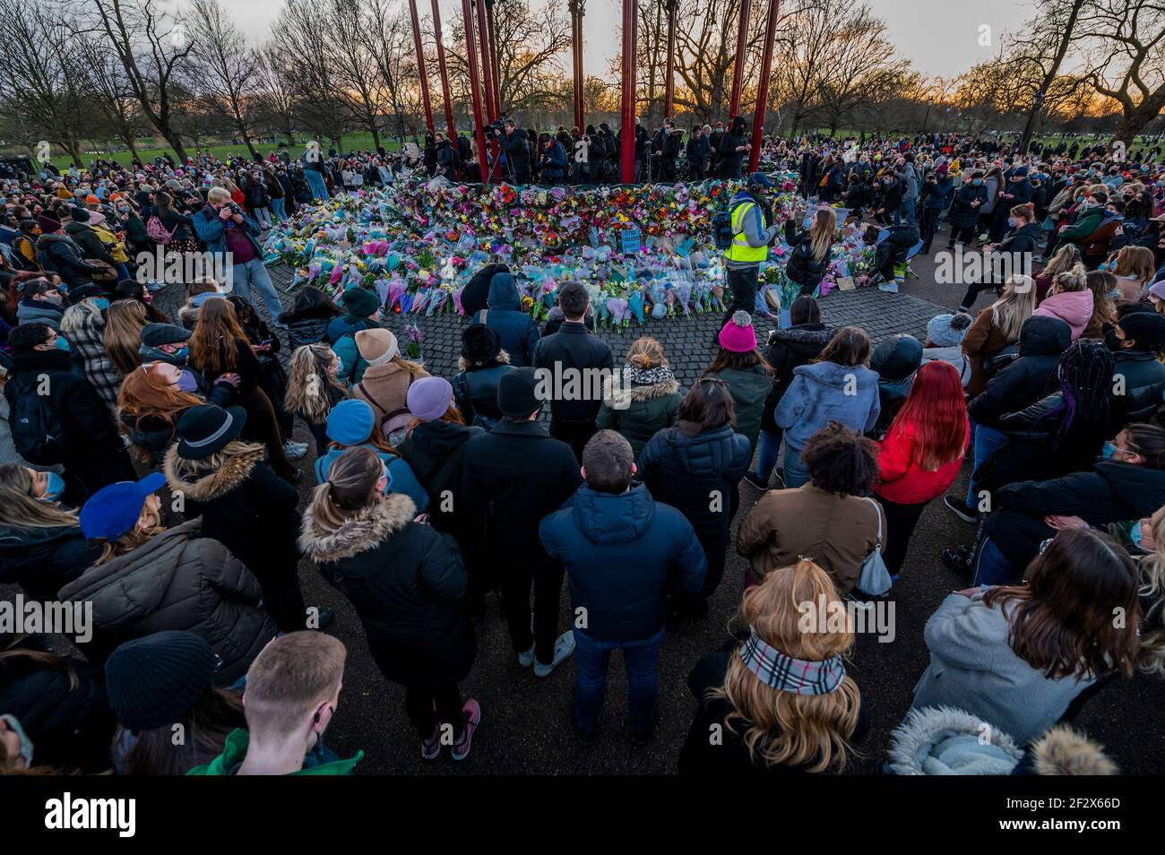 London, UK. 13th Mar, 2021. People gather to leave flowers and tributes for Sarah Everard at a vigil at the Bandstand where planned. Despite it being banned by the police under covid regulations. She disappeared after 9:00 on March 3 somewhere between Clapham Junction and Brixton. Credit: Guy Bell/Alamy Live News Stock Photo