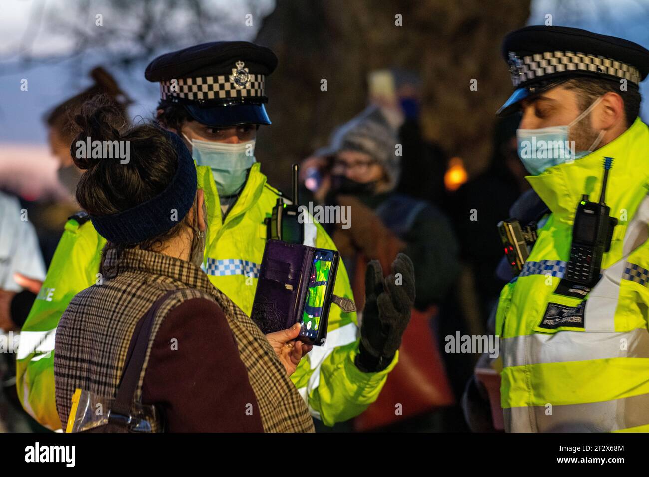 Hundreds of people gather on Clapham Common at the bandstand as a vigil for the murdered woman Sarah Everard - the vigil had been banned for lockdown Stock Photo