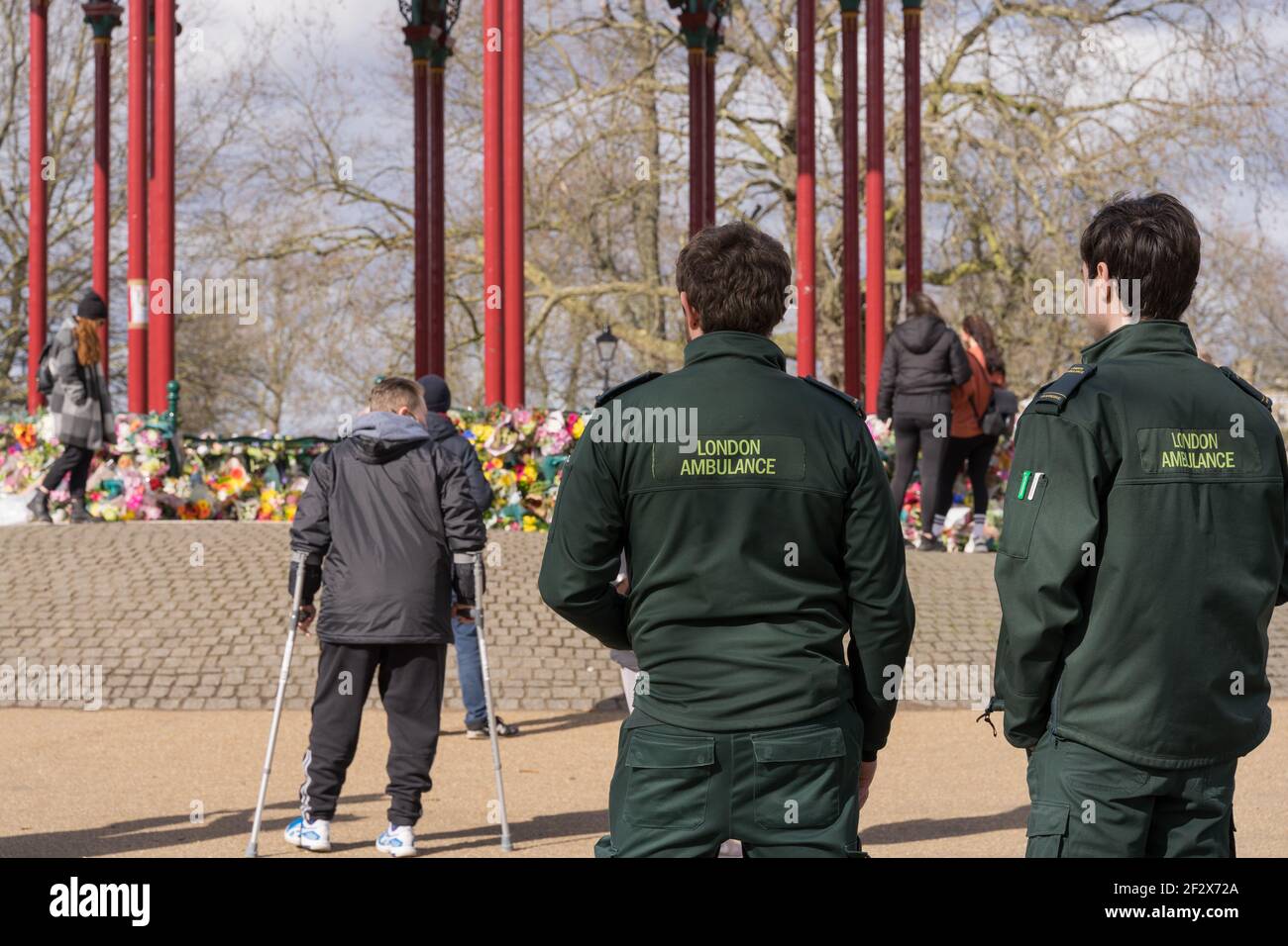 two ambulance staffs pay floral tributes at Clapham Common bandstand in memory of Sarah Everard, kidnaped and murdered , London, England Stock Photo