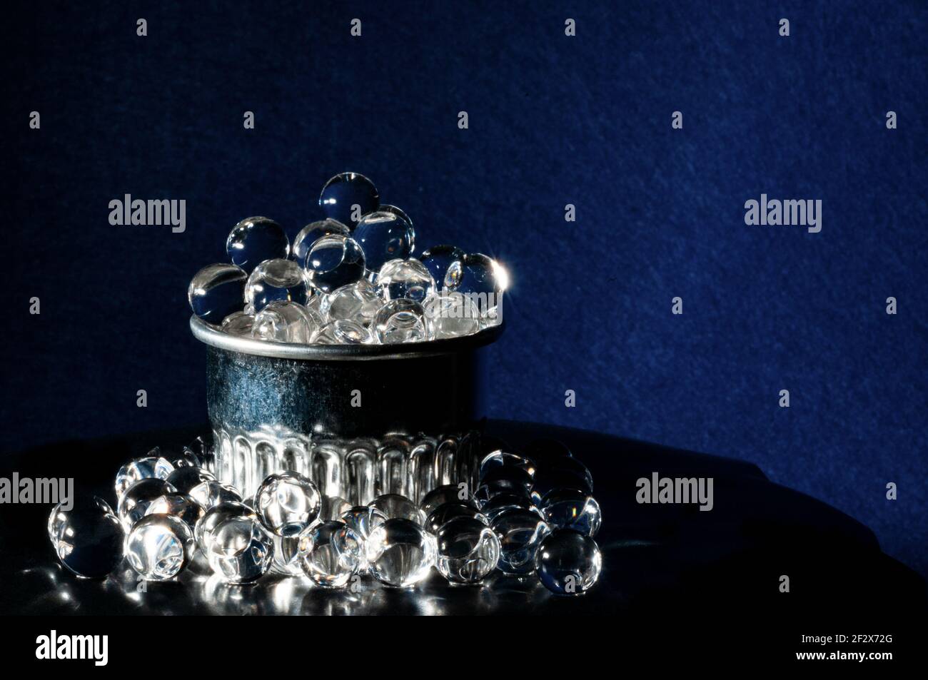 Old silver cup full of gray caviar in purple background and copy space Stock Photo