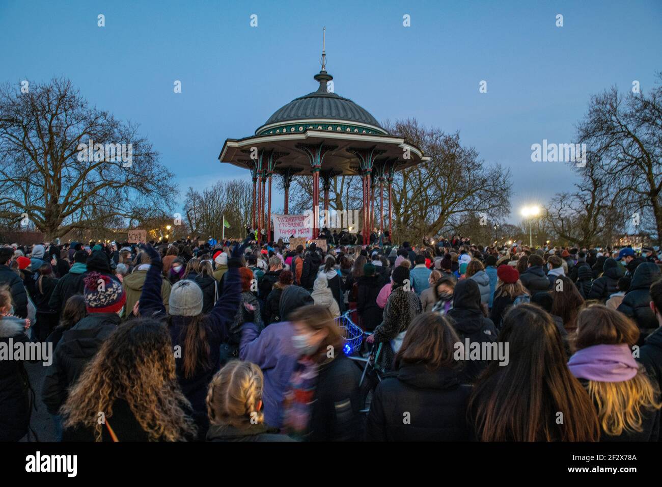 Hundreds of people gather on Clapham Common at the bandstand as a vigil for the murdered woman Sarah Everard - the vigil had been banned for lockdown Stock Photo