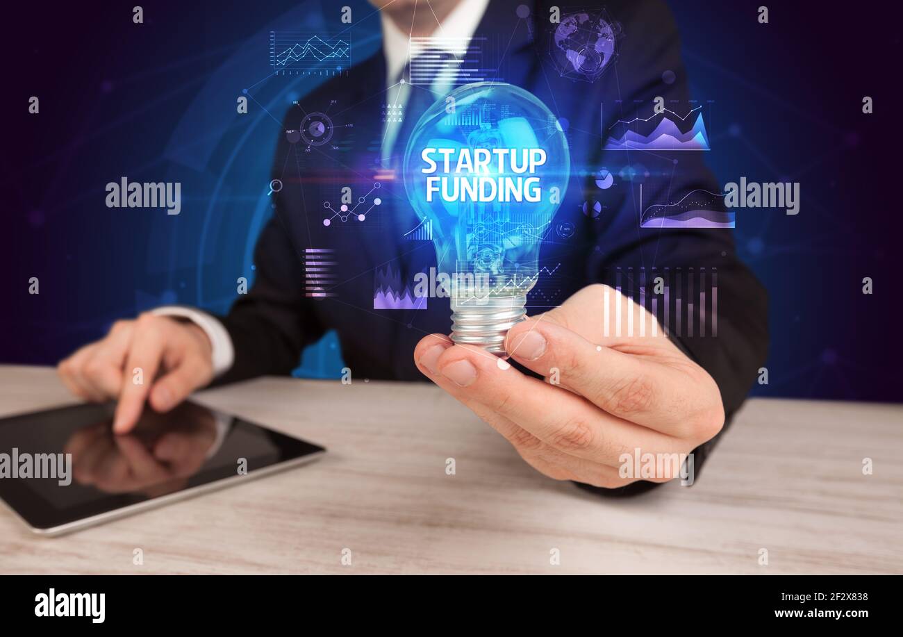 Businessman holding a light bulb, new business concept Stock Photo - Alamy