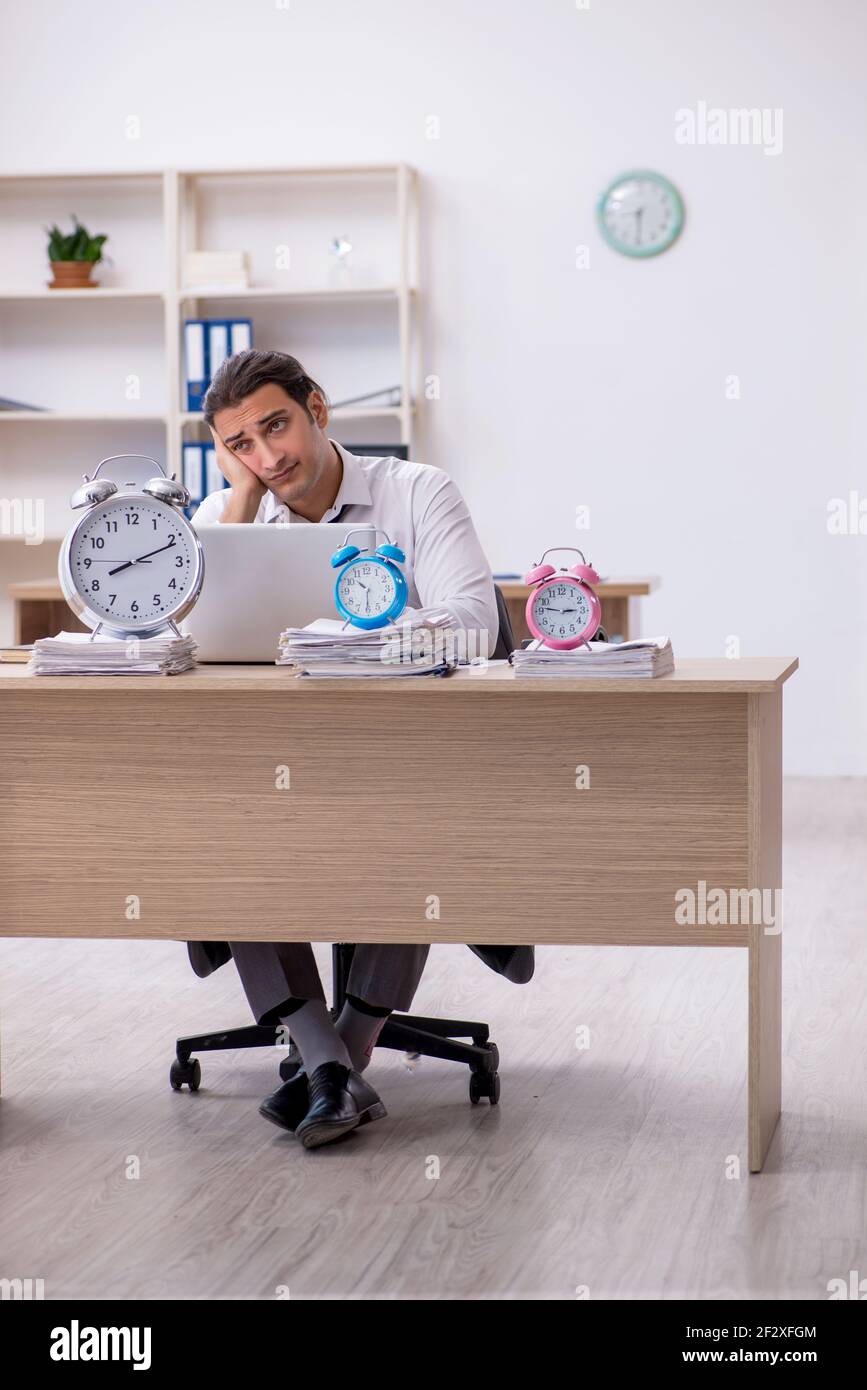 Picture of Young employee afraid of missing deadline at workplace Stock Photo - Alamy