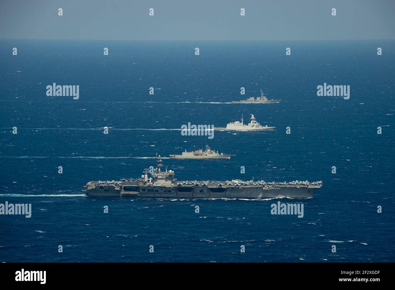 The U.S. Navy Nimitz-class aircraft carrier USS Dwight D. Eisenhower transits the Mediterranean Sea along with the Italian Navy Carlo Bergamini-class frigate Virginio Fasanon, Hellenic Navy Hydra-class frigate Psaraa and Arleigh-Burke class guided-missile destroyer USS Mitscher March 11, 2021 in the Mediterranean Sea. Stock Photo