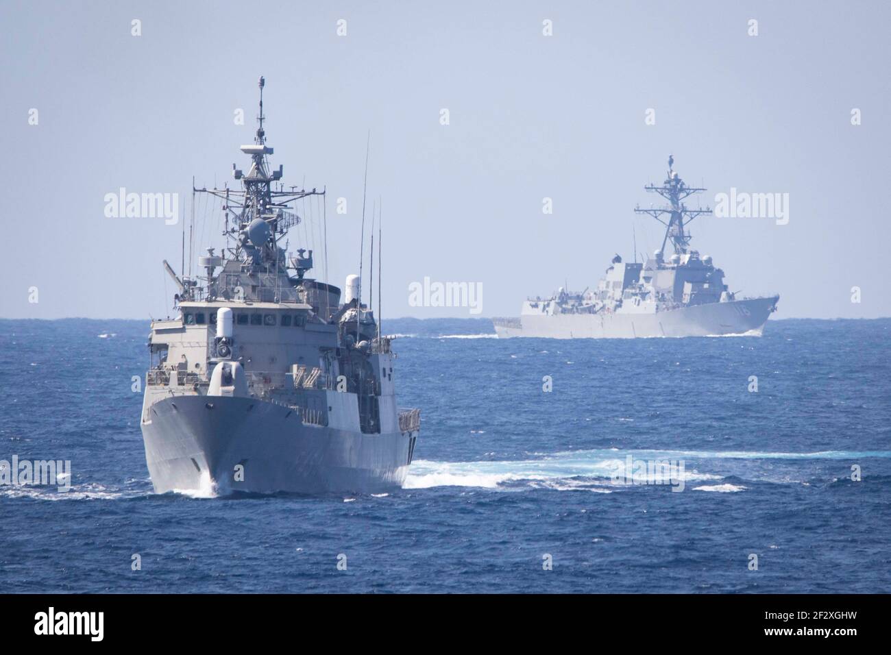 The Greek Navy Hydra-class frigate HS Psaraa, left, and the U.S. Navy Arleigh-Burke class guided-missile destroyer USS Thomas Hudner transits the Mediterranean Sea in formation with the Eisenhower Carrier Strike Group March 12, 2021 in the Mediterranean Sea. Stock Photo
