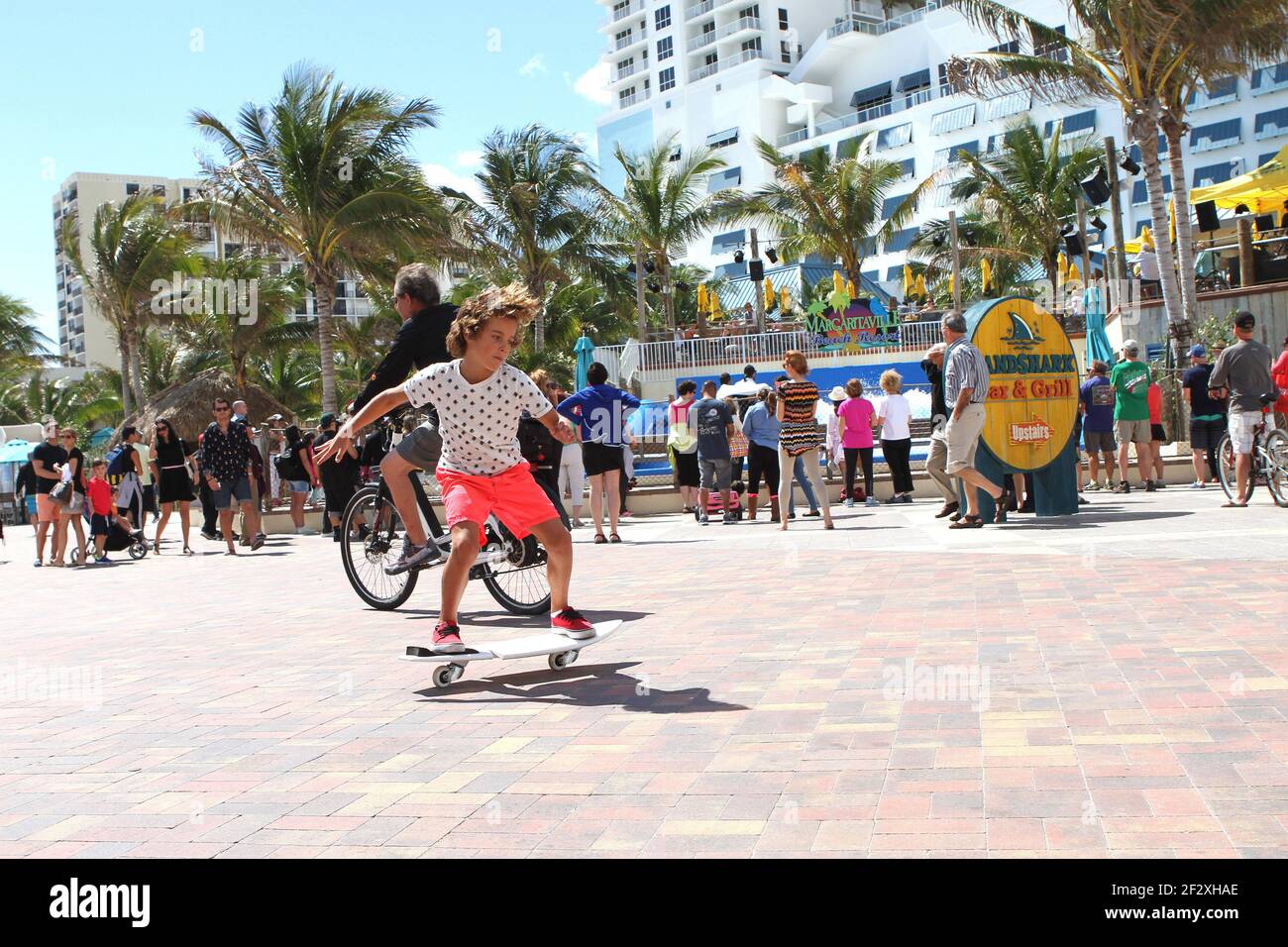 Hollywood Beach Broadwalk attracts people who like to bike, skate and jog on a sunny day. Stock Photo