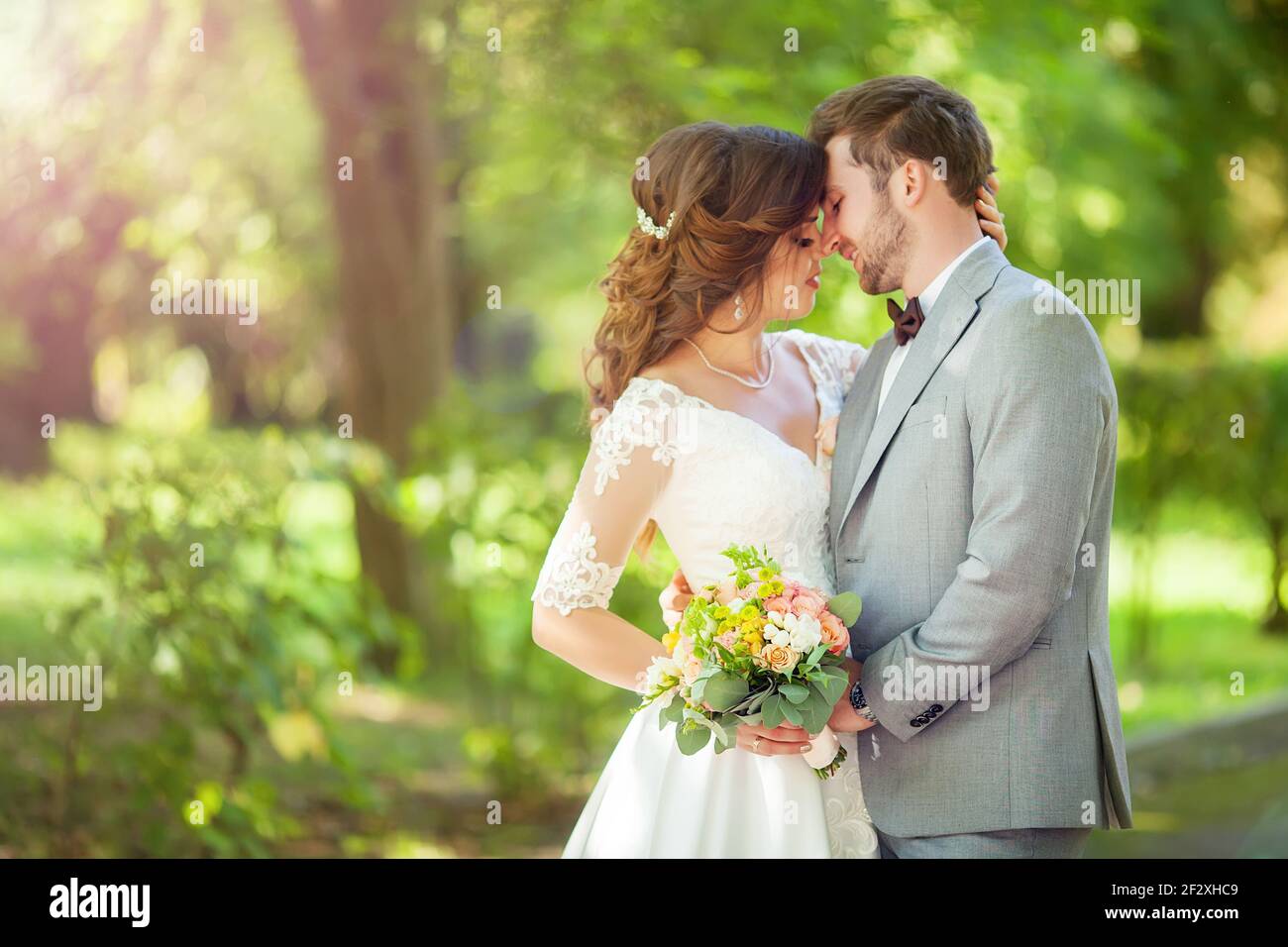 happy bride and groom at a park on their wedding day Stock Photo - Alamy