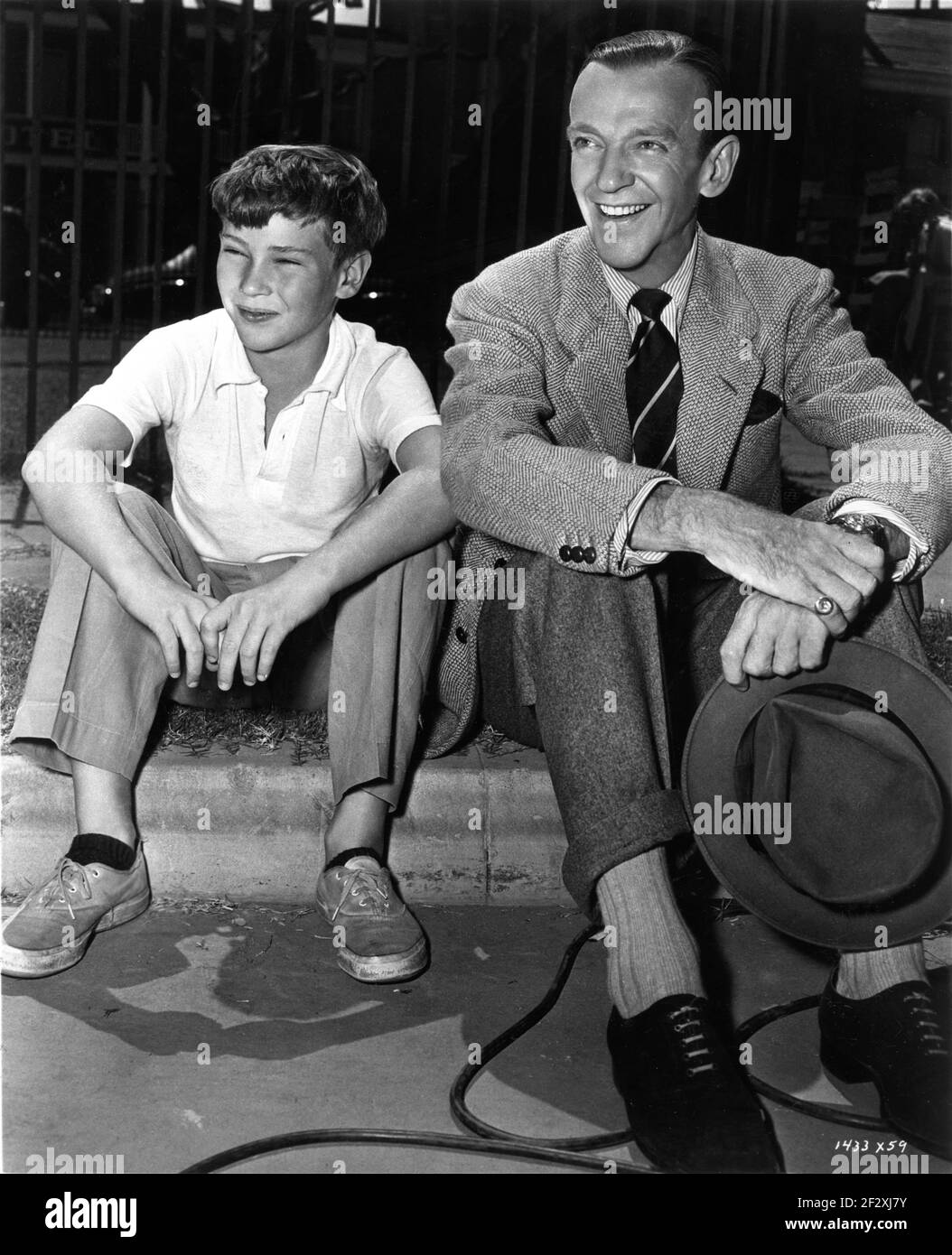 FRED ASTAIRE with his son FRED ASTAIRE JR on set candid watching Ginger Rogers perform a scene during filming of THE BARKELEYS OF BROADWAY 1949 director CHARLES WALTERS original screenplay Betty Comden and Adolph Green producer Arthur Freed Metro Goldwyn Mayer Stock Photo