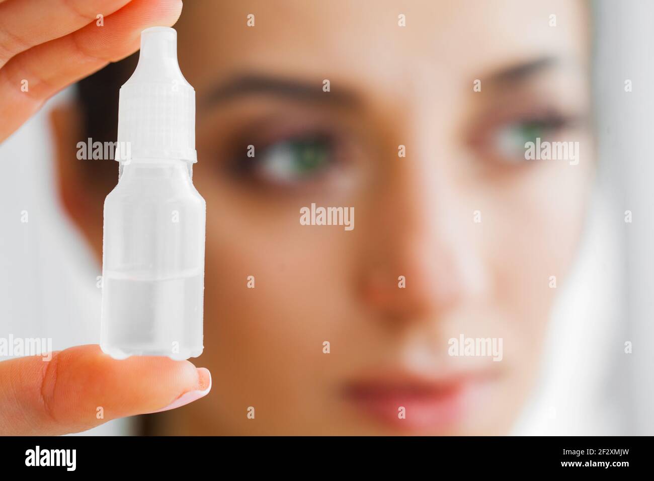 Vision And Medicine Concept. Young Girl Holds Eye Drops In Hands