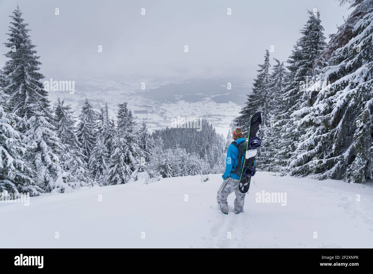 Snowboarder looking at landscape Stock Photo