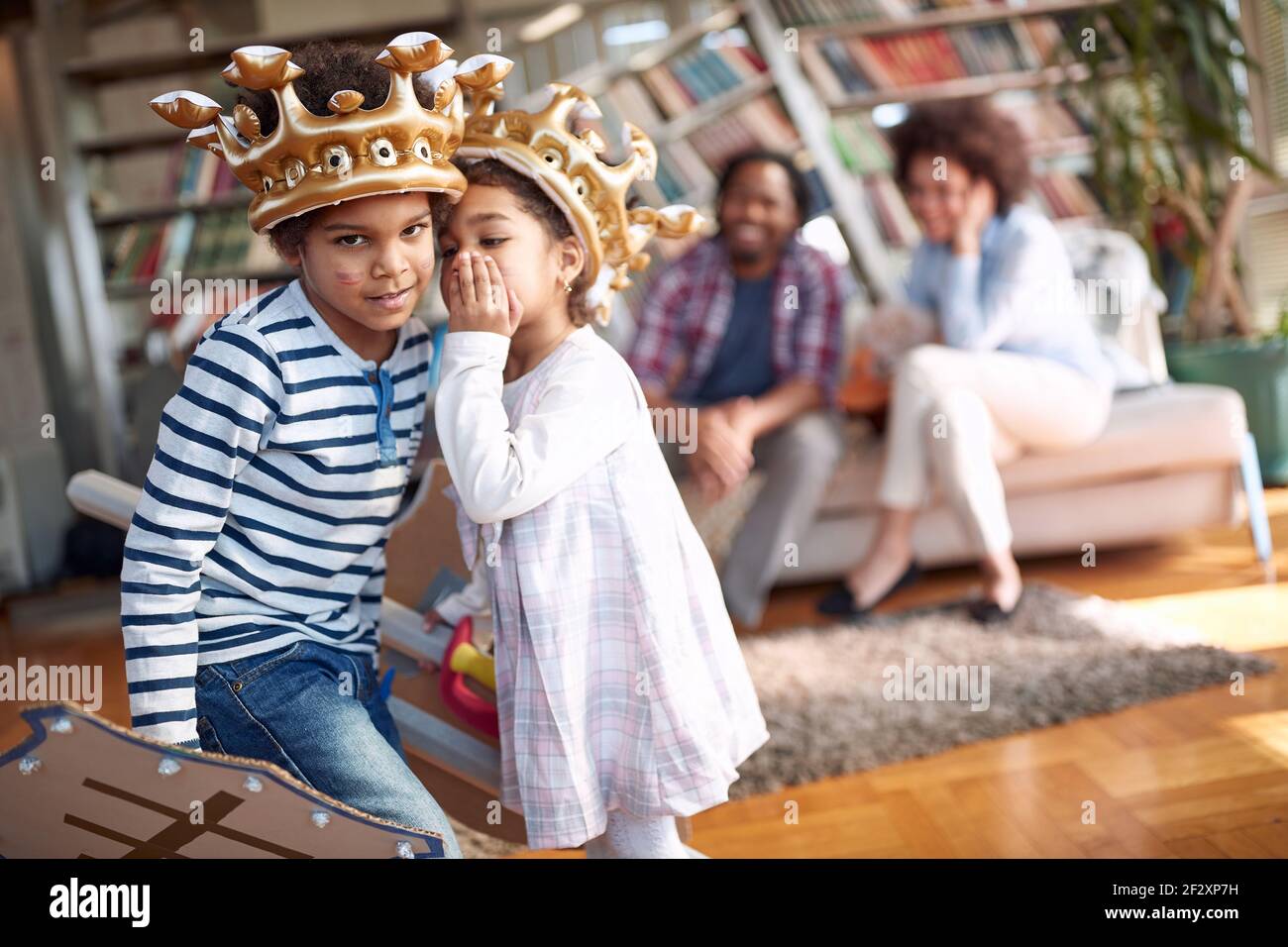 Kids are posing in a family atmosphere at home and whispering some secrets. Family, together, love, playtime Stock Photo