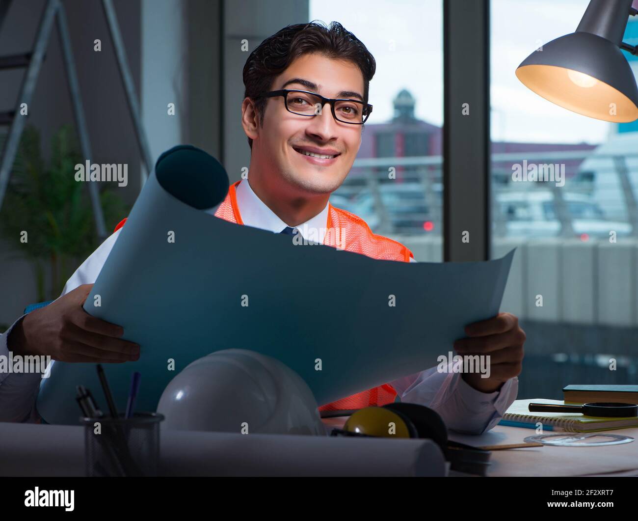 The construction architect working on drawings late at night Stock Photo