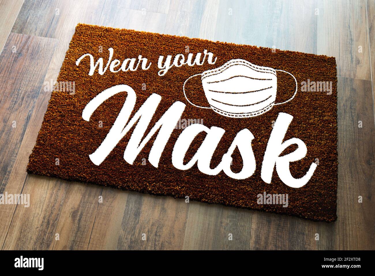 Wear Your Mask Welcome Door Mat on Wood Floor. Stock Photo