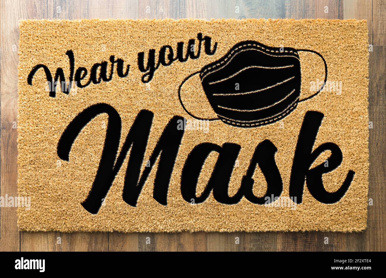 Wear Your Mask Welcome Door Mat on Wood Floor. Stock Photo