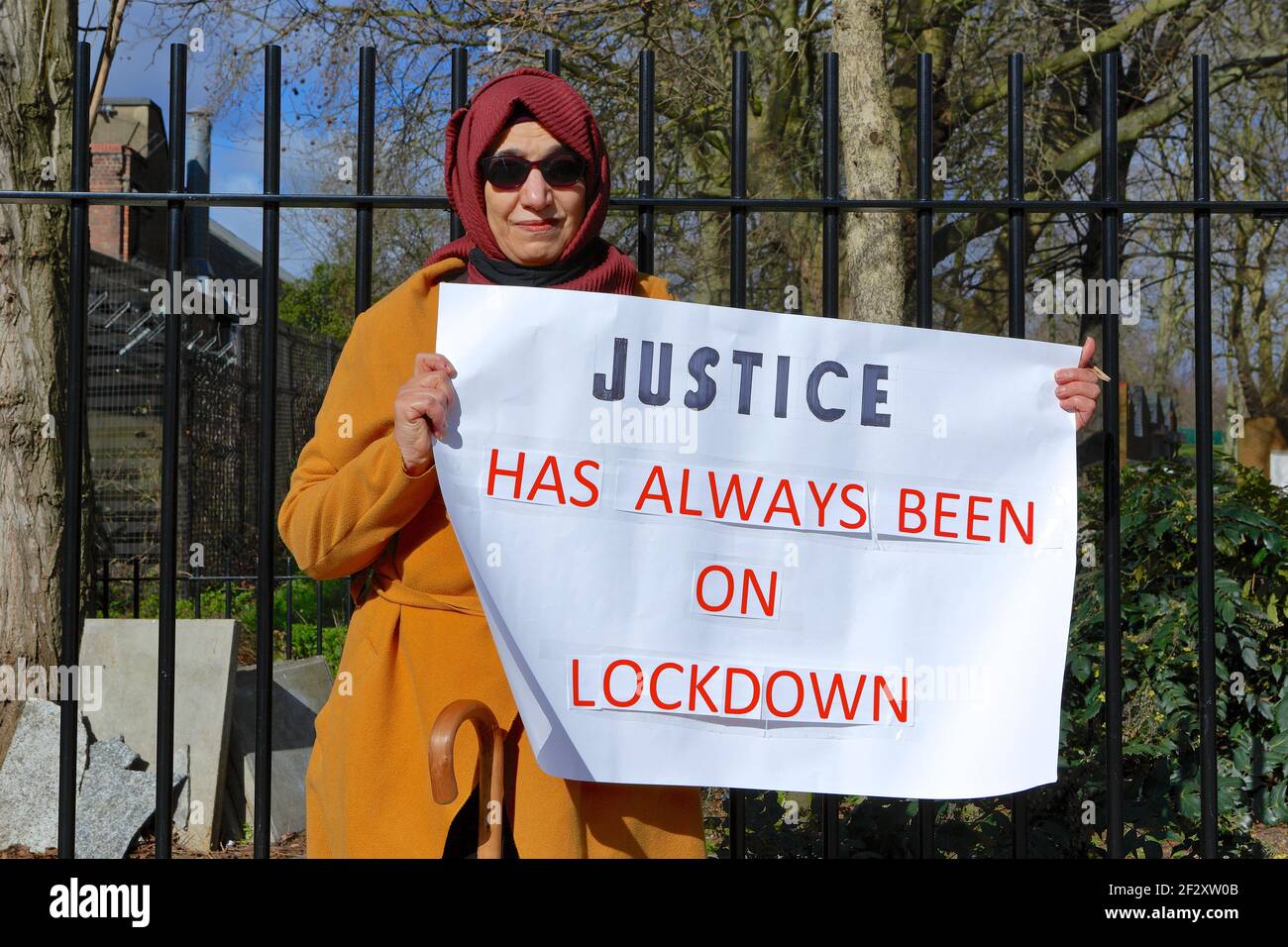 London (UK), March 13 2021: Hiva Boudiaf, mother of murder victim Karim Boudiaf holds up banner on the day preceding the 2021 Mothers Day.Karim was sh Stock Photo