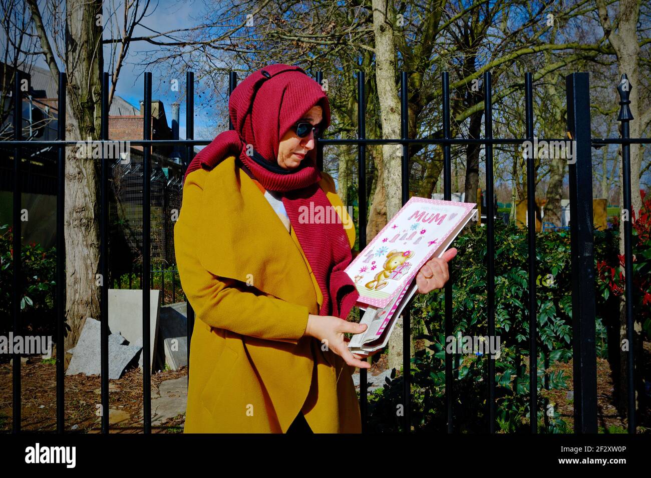 London (UK), March 13 2021: Hiva Boudiaf, mother of murder victim Karim Boudiaf holds up a mothers day card on the day preceding the 2021 Mothers Day. Stock Photo