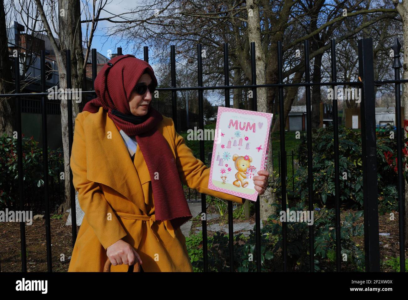 London (UK), March 13 2021: Hiva Boudiaf, mother of murder victim Karim Boudiaf holds up a mothers day card on the day preceding the 2021 Mothers Day. Stock Photo
