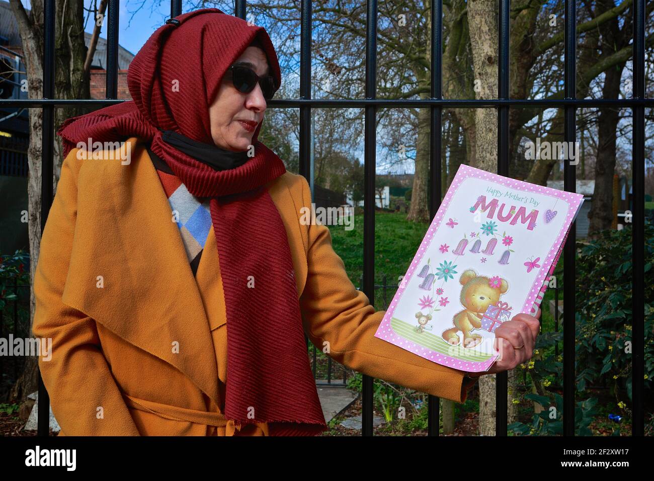 London (UK), March 13 2021: Hiva Boudiaf, mother of murder victim Karim Boudiaf holds up a mothers day card on the day preceding the 2021 Mothers Day. Stock Photo