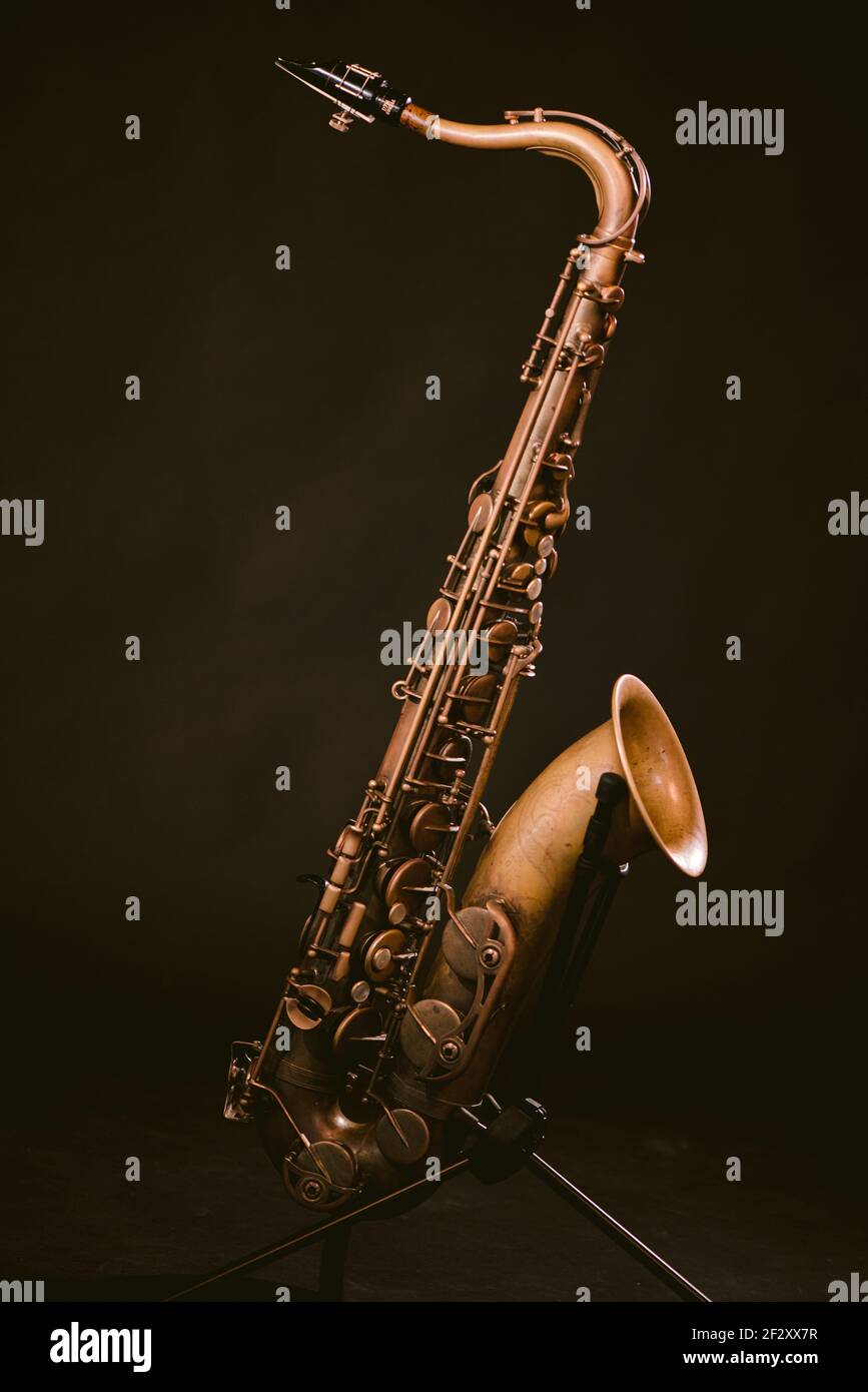 Contemporary classic brass wind instrument saxophone isolated on black background in musical studio Stock Photo
