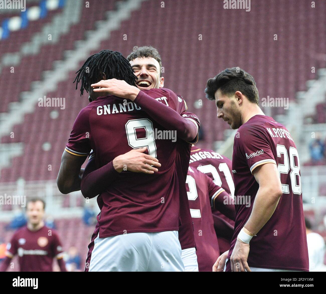 Tynecastle Park, Edinburgh, Scotland. UK .13th March 21. Scottish Championship Match .Hearts vs Ayr Utd Hearts' French striker, Armand Gnanduillet, (9) celebrates his goal with midfielder, Andy Irving, Credit: eric mccowat/Alamy Live News Stock Photo