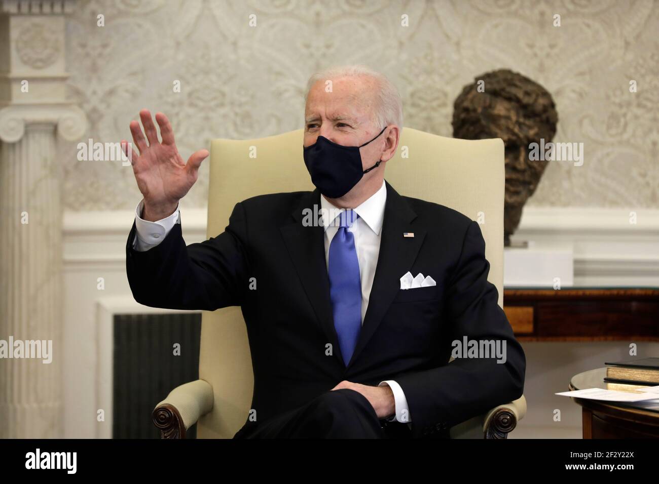 U.S. President Joe Biden holds a hockey jersey with his name on it