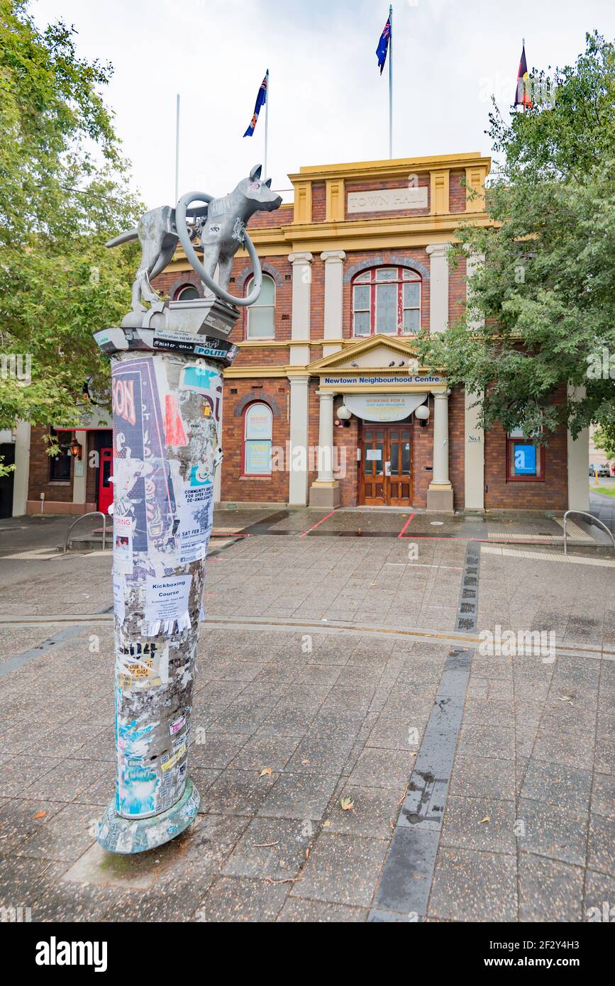 One of three Guardian Dog statues mounted on a poster bollard. This one located in Newtown Square in inner Sydney, Australia Stock Photo