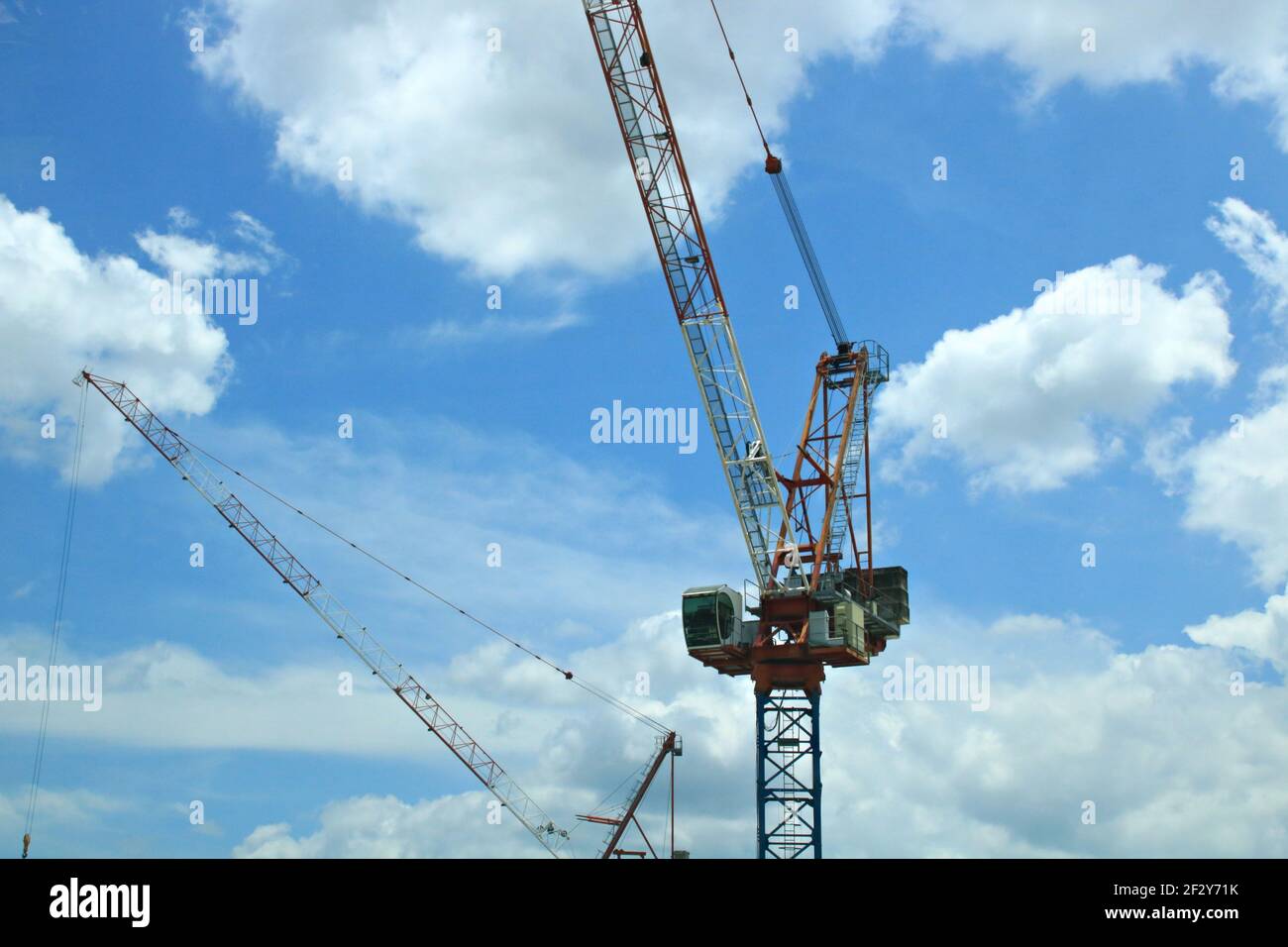 Construction crane on a cloudy bright sky Stock Photo - Alamy