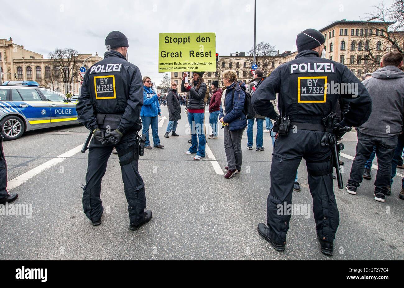 Munich, Bavaria, Germany. 13th Mar, 2021. A sign of the conspiracy ''The Great Reset'' being displayed at police in Munich, Germany. Using the occasion of Germany going into a period of anti-Corona measures approximately one year ago, Corona deniers and anti-maskers led by Querdenken's Markus Haintz assembled at Munich's Marienplatz and then at the Maxmonument in an effort to protest against the Bavarian Landtag and promote their initiative to dissolve it and install a provisional government, presumably made of right-extremists, conspiracy theorists, QAnons, Libertarians, and anti-masker Stock Photo