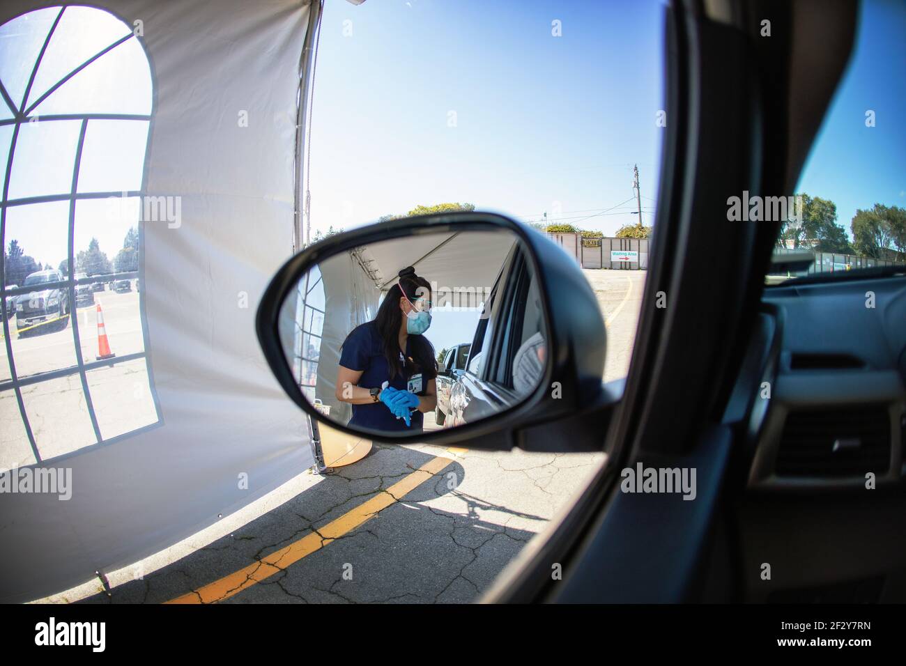 A nurse prepares to deliver a Covid-19 shot at a Sutter Health drive through vaccination site in Santa Cruz, California.  March 2021 Stock Photo
