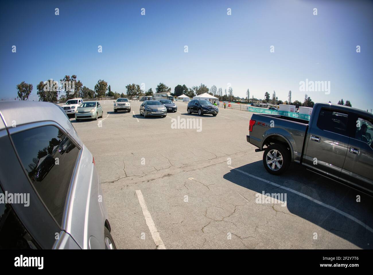 Vaccination recipients wait in their cars after a Covid-19 shot at a drive through vaccination site in Santa Cruz, California.  March 2021 Stock Photo