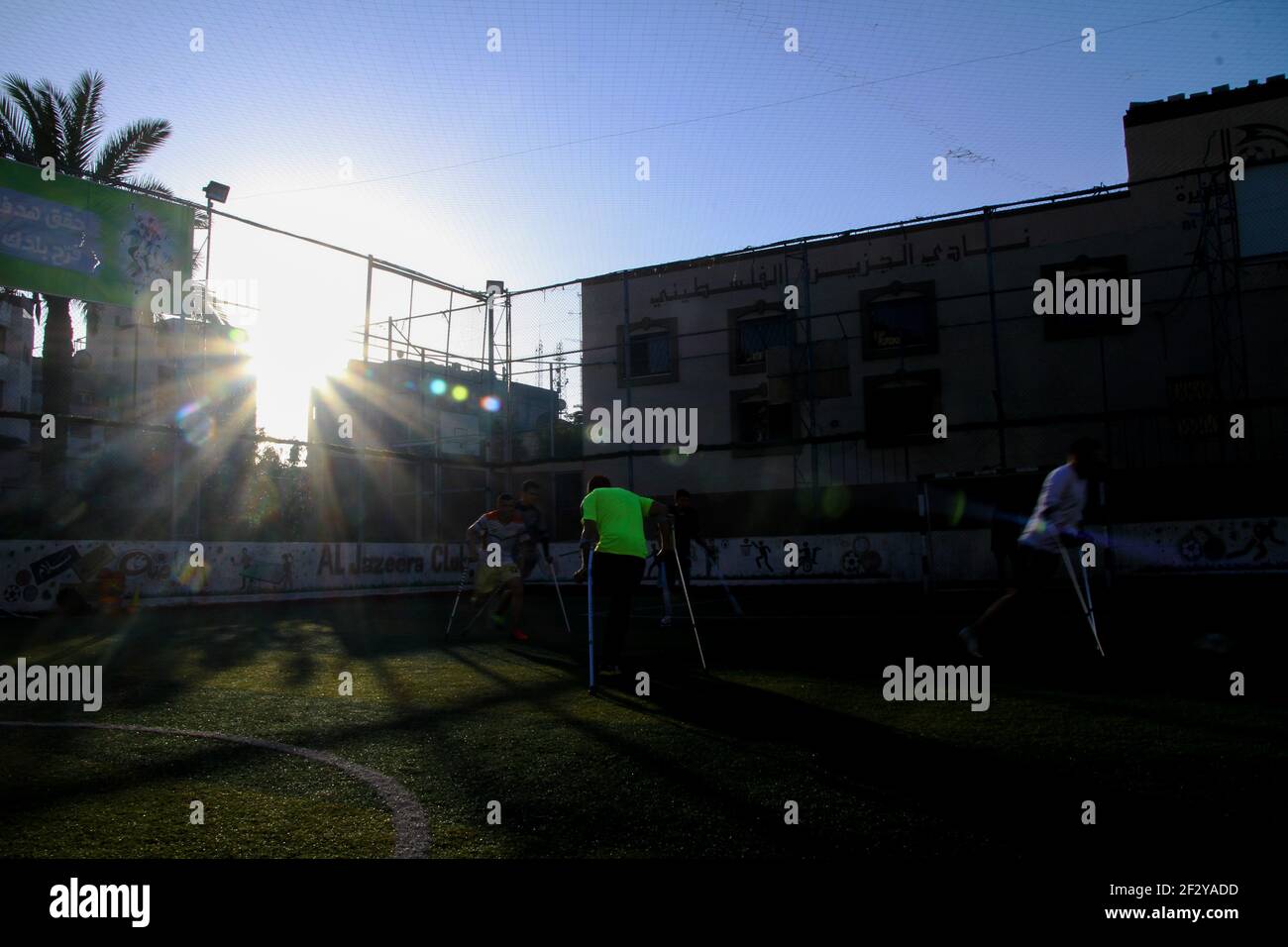 March 13, 2021: Gaza, Palestine. 13 March 2021. Palestinians with crutches play football in the Al-Jazeera Club in Gaza City on the 'Palestinian Day of the injured''. The players have lost a leg either in Israeli attacks on Gaza or in the March of Return demonstrations, during which they were shot to their limbs by Israeli soldiers based at the perimeter fence with Gaza. Some of the severe limb gunshot wounds have required complex limb reconstruction treatments, while others have required amputation. Yet, despite losing a leg, many Palestinians have not lost their resilience and determinati Stock Photo