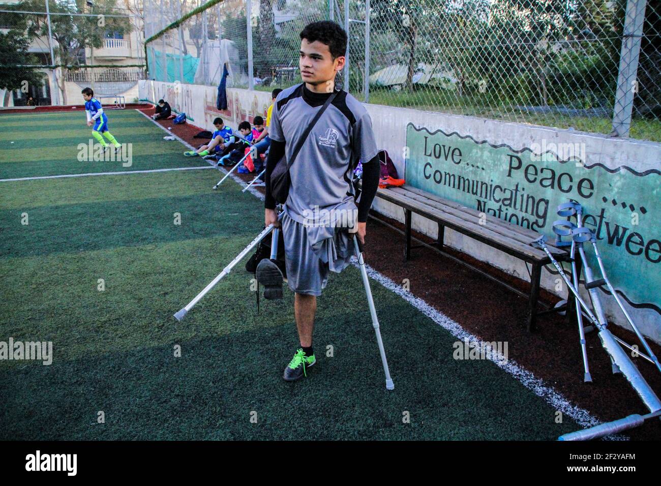 March 13, 2021: Gaza, Palestine. 13 March 2021. Palestinians with crutches play football in the Al-Jazeera Club in Gaza City on the 'Palestinian Day of the injured''. The players have lost a leg either in Israeli attacks on Gaza or in the March of Return demonstrations, during which they were shot to their limbs by Israeli soldiers based at the perimeter fence with Gaza. Some of the severe limb gunshot wounds have required complex limb reconstruction treatments, while others have required amputation. Yet, despite losing a leg, many Palestinians have not lost their resilience and determinati Stock Photo