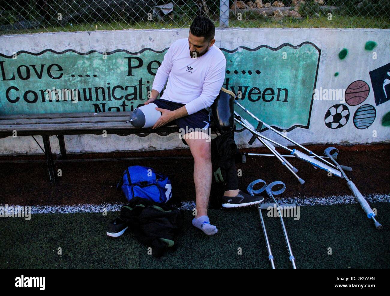 March 13, 2021: Gaza, Palestine. 13 March 2021. Palestinians with crutches play football in the Al-Jazeera Club in Gaza City on the 'Palestinian Day of the injured''. The players have lost a leg either in Israeli attacks on Gaza or in the March of Return demonstrations, during which they were shot to their limbs by Israeli soldiers based at the perimeter fence with Gaza. Some of the severe limb gunshot wounds have required complex limb reconstruction treatments, while others have required amputation. Yet, despite losing a leg, many Palestinians have not lost their resilience and determinati Stock Photo