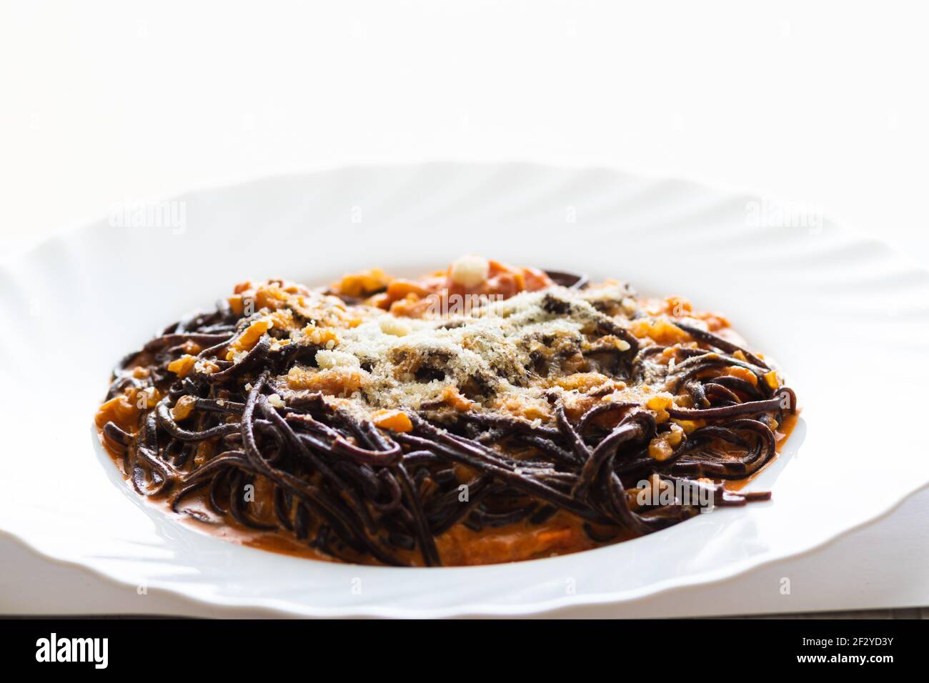 Organic black rice noodle in tomato cream sauce, with parmesan cheese