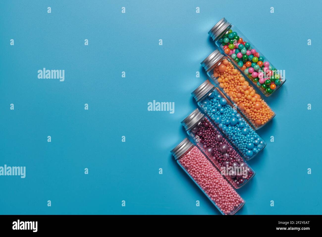 candy in jars on a blue background Stock Photo