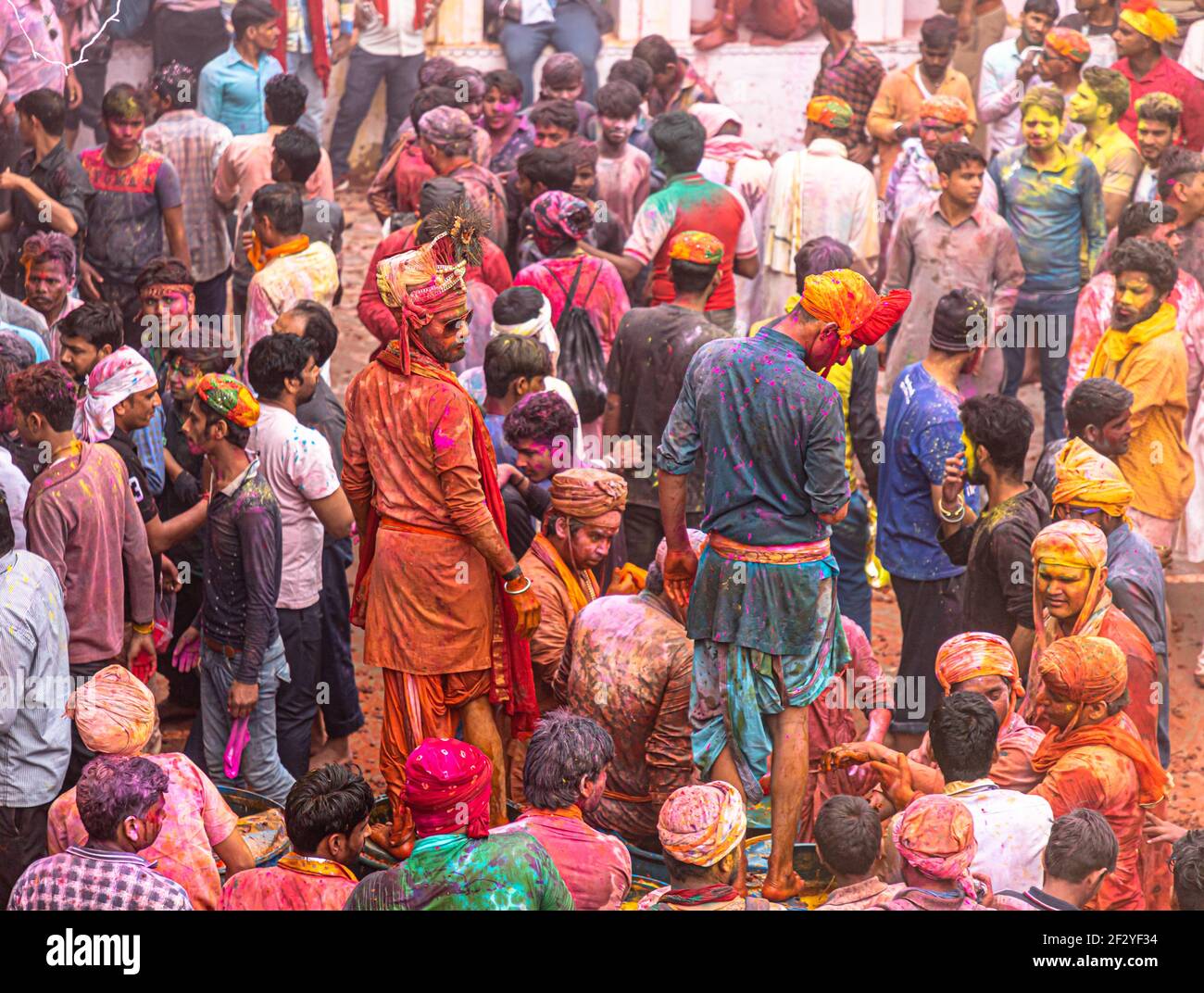 people celebrating and playing holi at nandgaon,mathura, with selective focus on subject with added noise and grains. Stock Photo