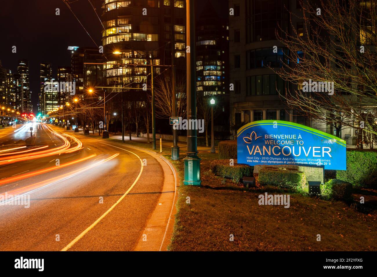 Welcome to Vancouver winter games sign board with downtown night street view. British Columbia, Canada. Stock Photo