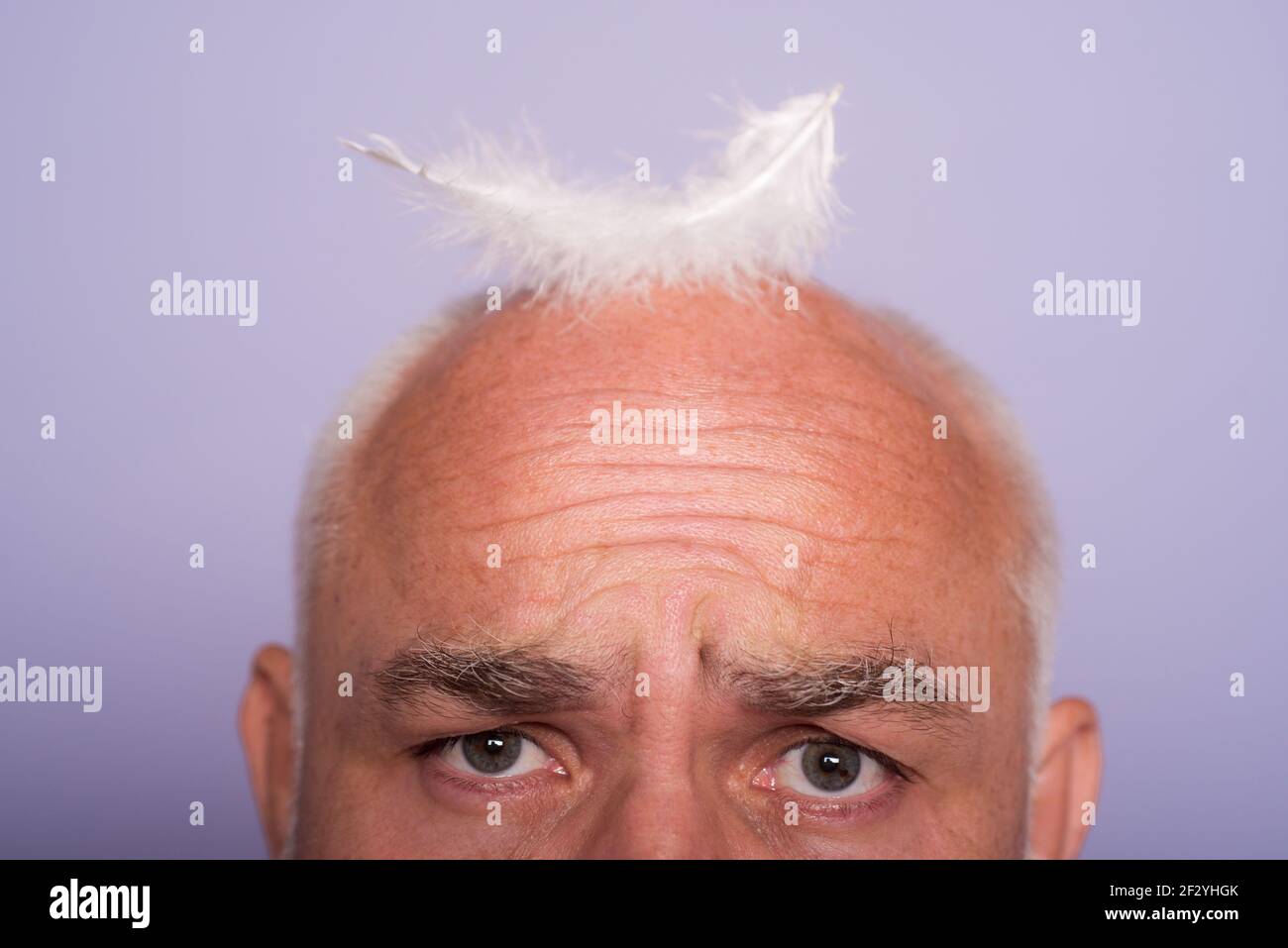 bald asian gets dressed in feathers