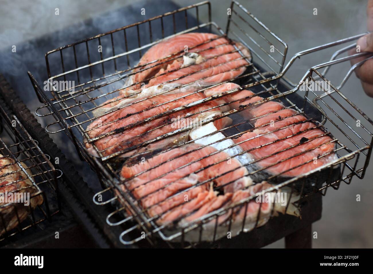 Cooking of salmon steaks on a barbecue grill Stock Photo - Alamy