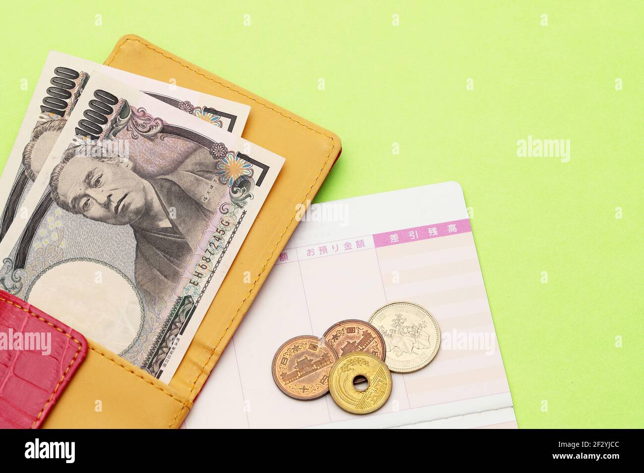 Leather wallet with ten thousand japanese yen and passbook. Stock Photo