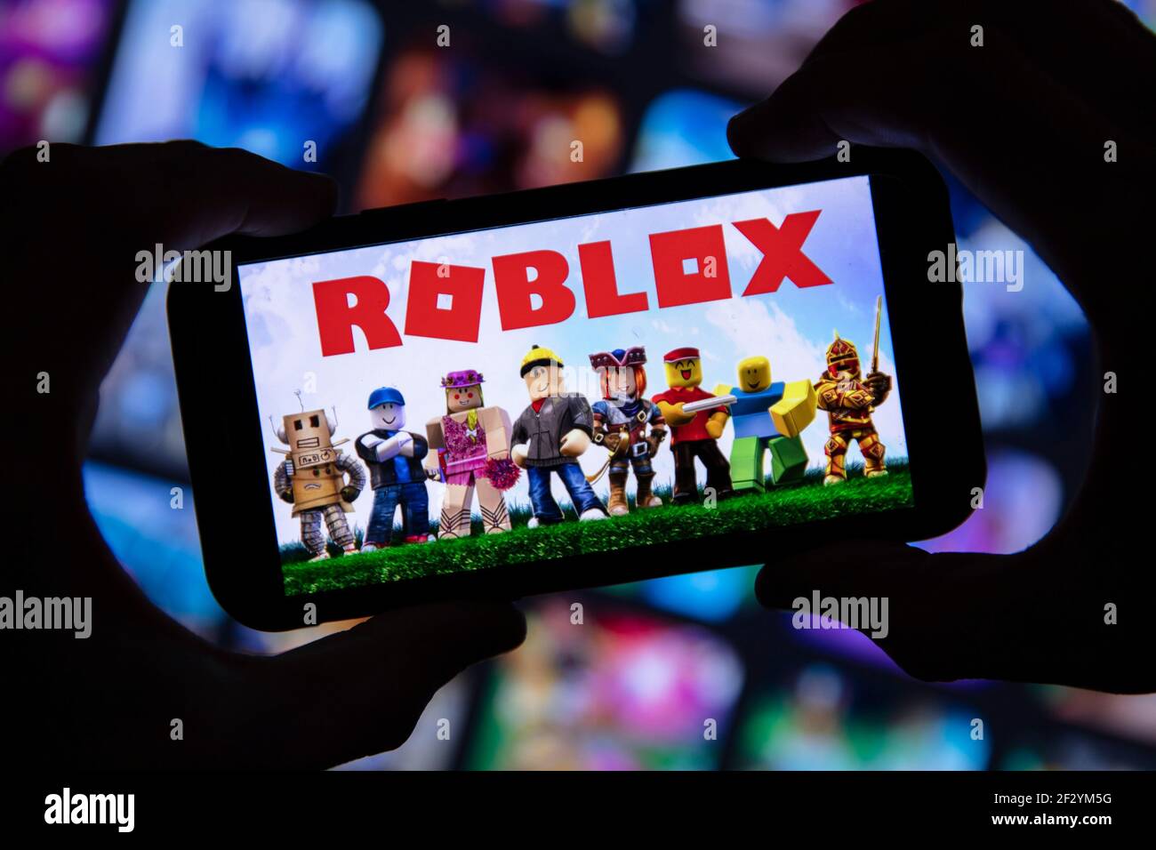 London Uk March 2021 Person Holding A Smartphone With Roblox Game Logo Stock Photo Alamy - game logo roblox